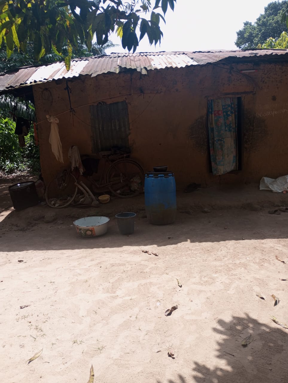 Water barrels stored outside the home of a resident.